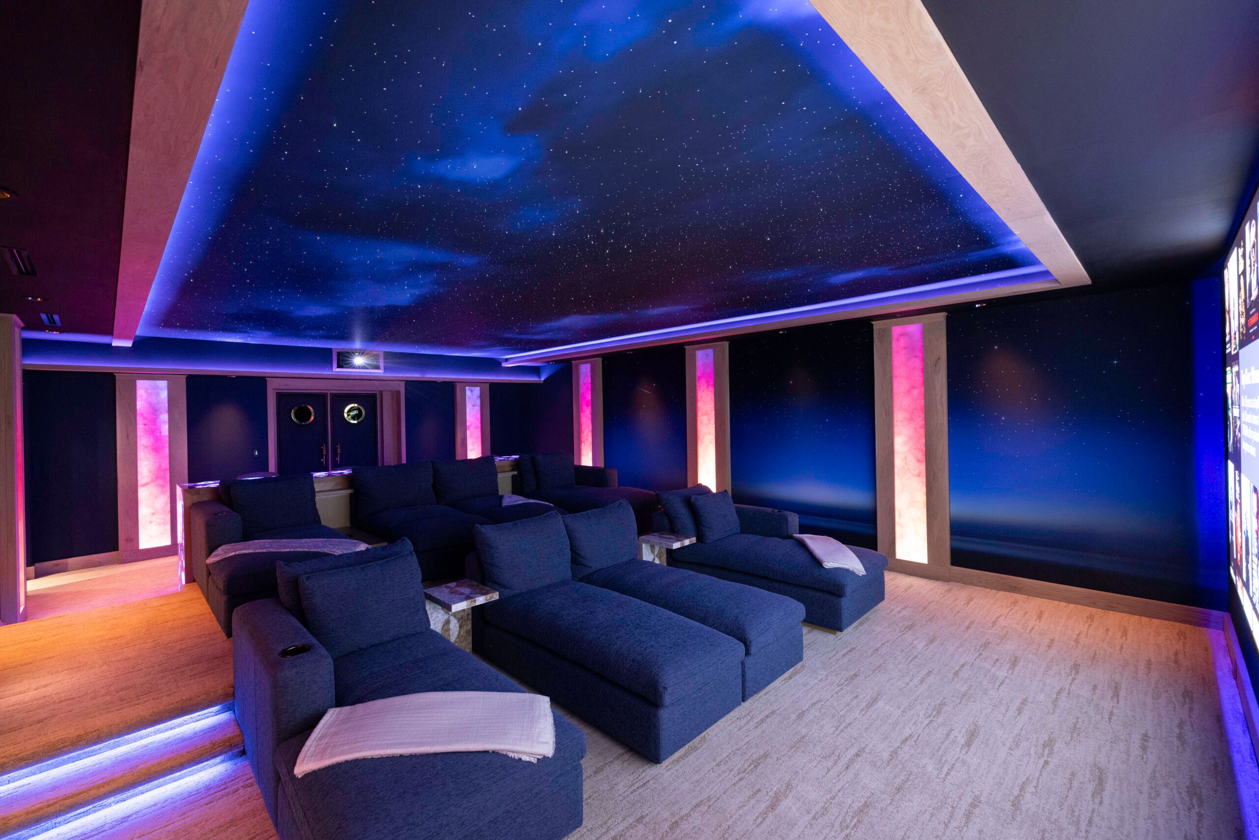 Innovative Sight & Sound home theater with a starlit ceiling and lounge seating