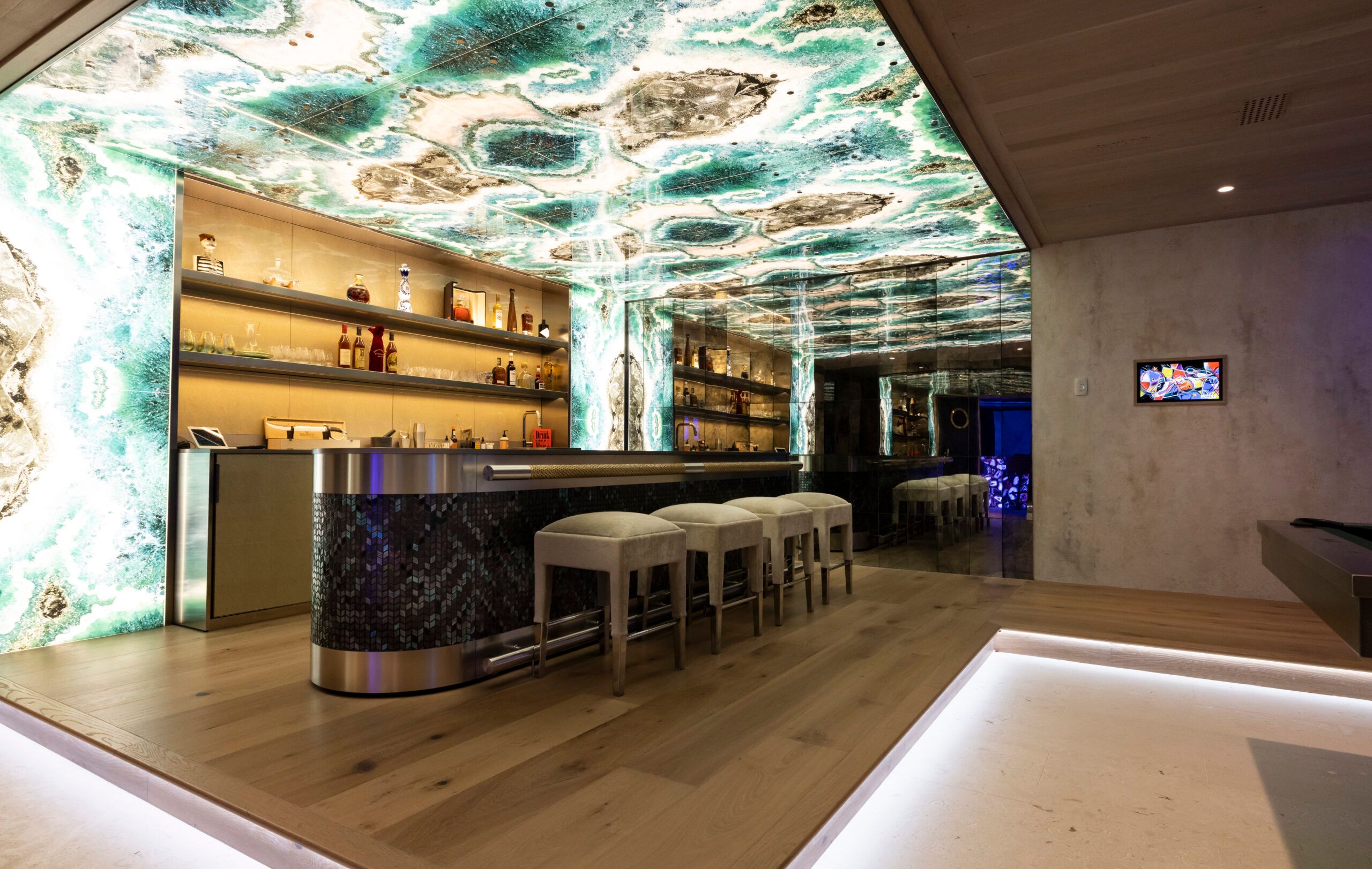 Bar with backlit stone ceiling and integrated lighting